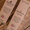 packaged moringa oil positioned on a wooden surface